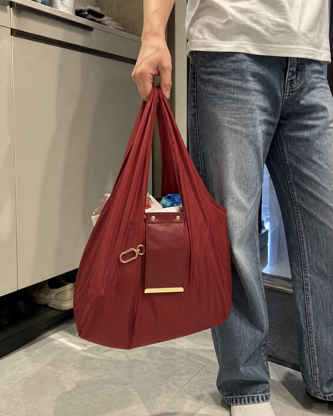 Red foldable tote carried on the street