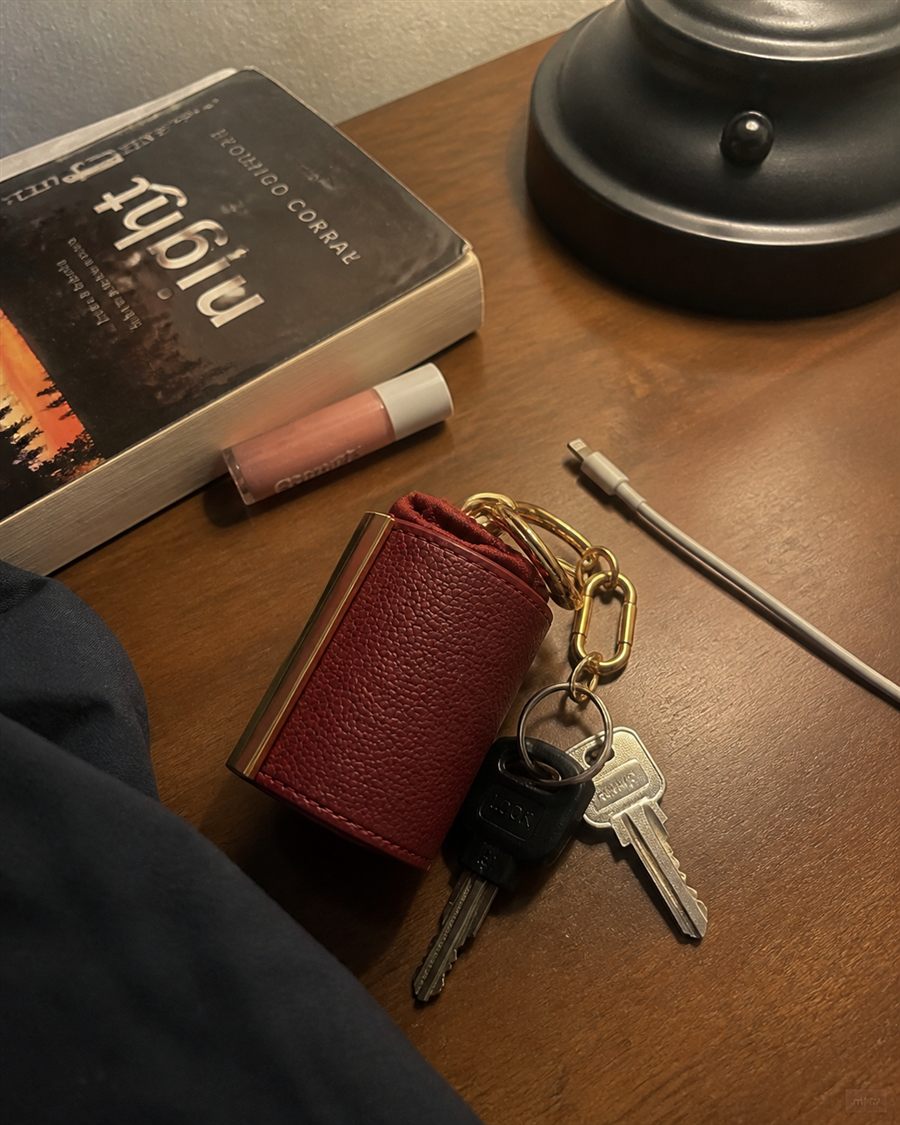 Red charm on keys on a nightstand