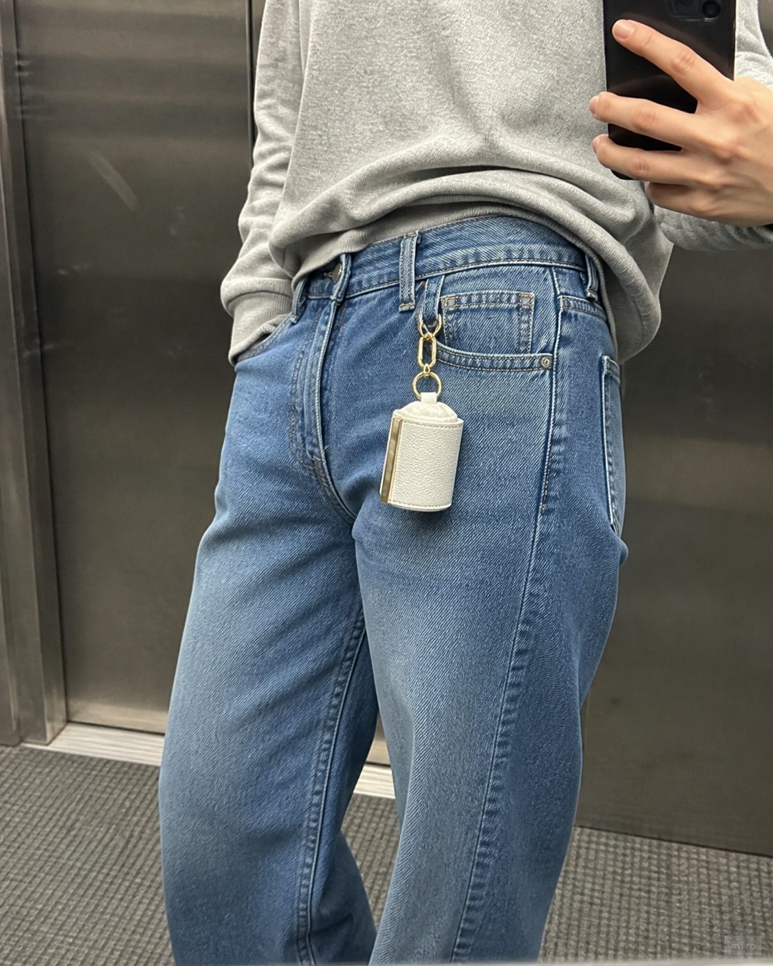 White charm on a belt loop