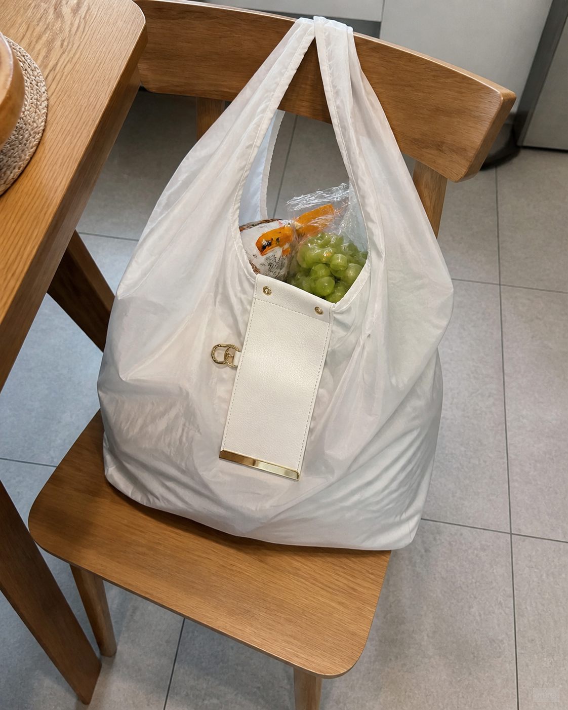 White foldable tote full of groceries